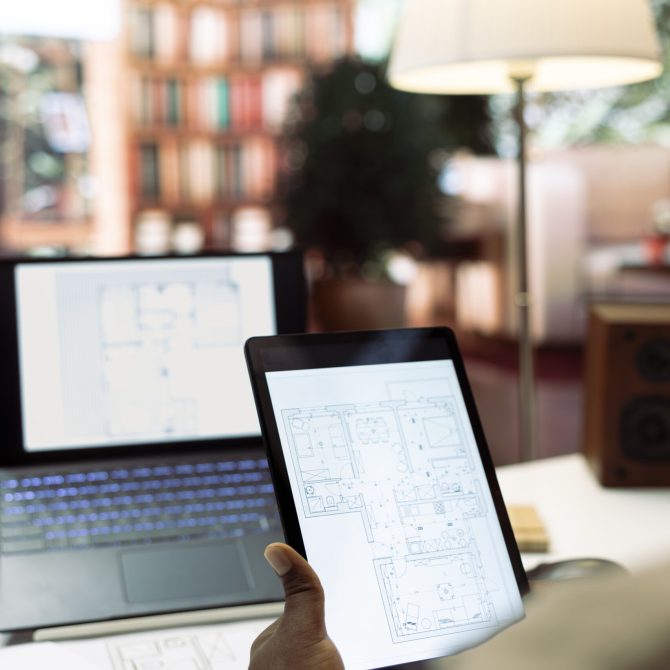 Entrepreneur conducting research and evaluating office spaces layouts on architectural blueprints, focusing on real estate investment strategy for business development. Close up.